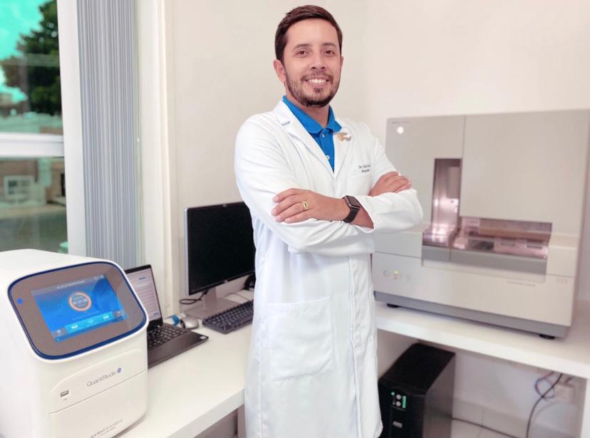 Victor Lima, coordenador de biologia molecular do DNA CENTER, ao lado de sequenciador genético